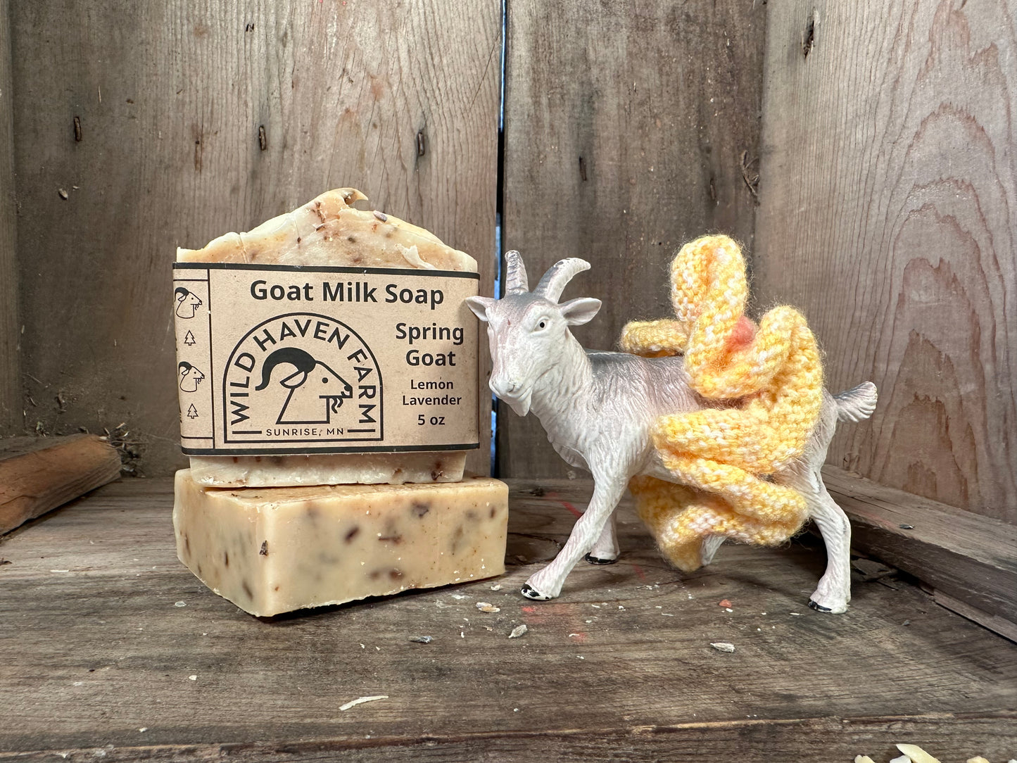 Bars of Wild Haven Farm's Spring Goat goat milk soap with a toy goat standing next to them.