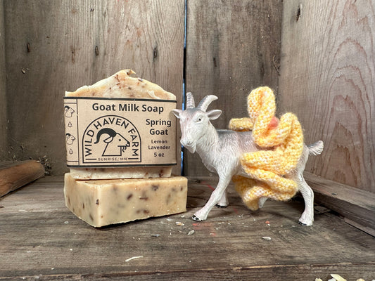 Bars of Wild Haven Farm's Spring Goat goat milk soap with a toy goat standing next to them.