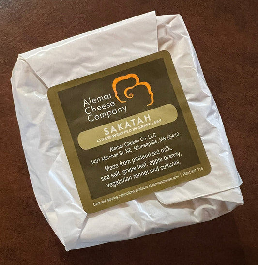 Package of Sakatah cheese wrapped in grape leaf from Alemar Cheese Company